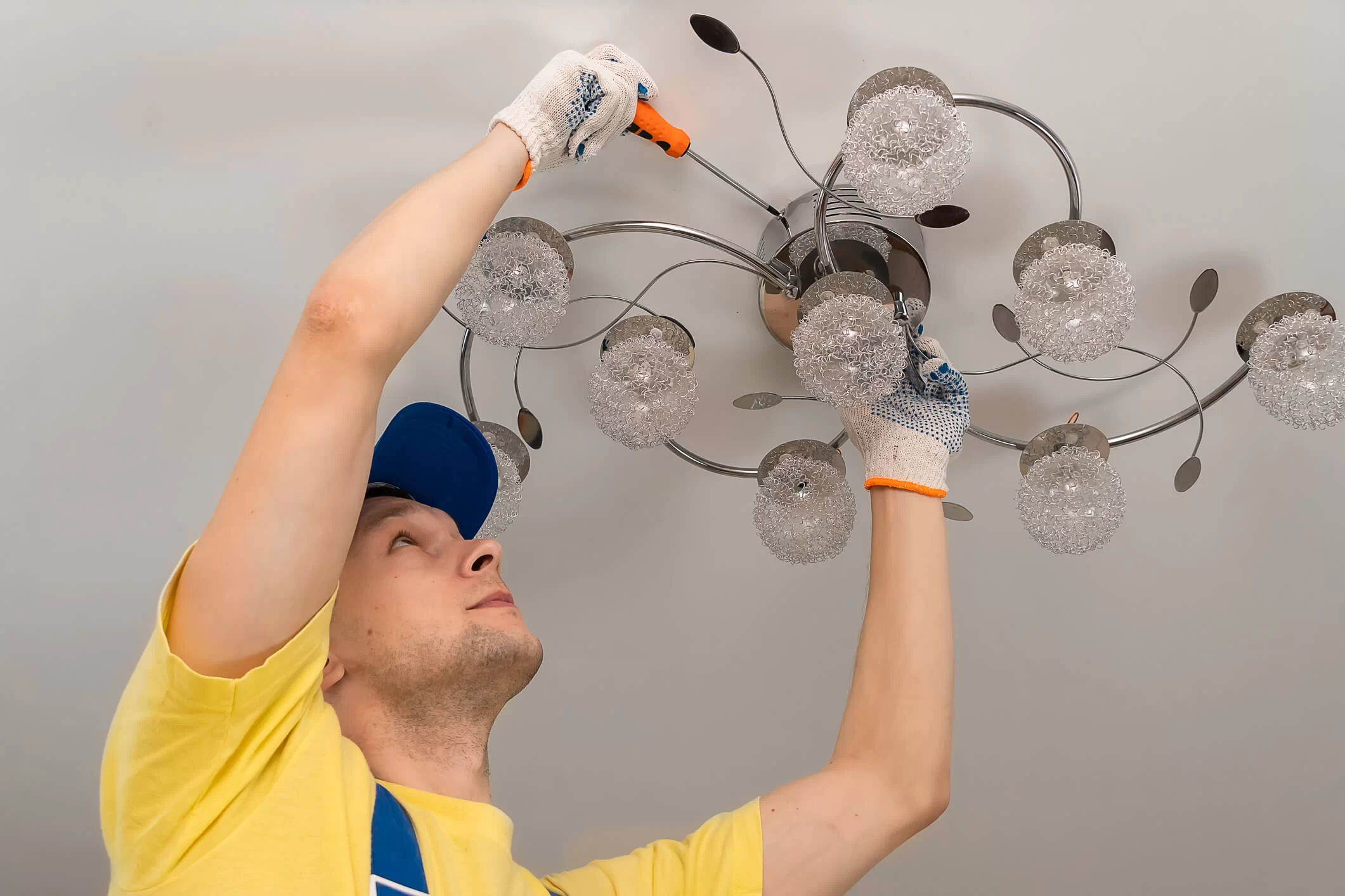 professional installing a chandelier